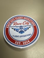 Rep your flight school wherever you land. Grab a Race City Flight Operations patch for your flight bag, backpack, or jacket. Only $2 at the front desk, or online!